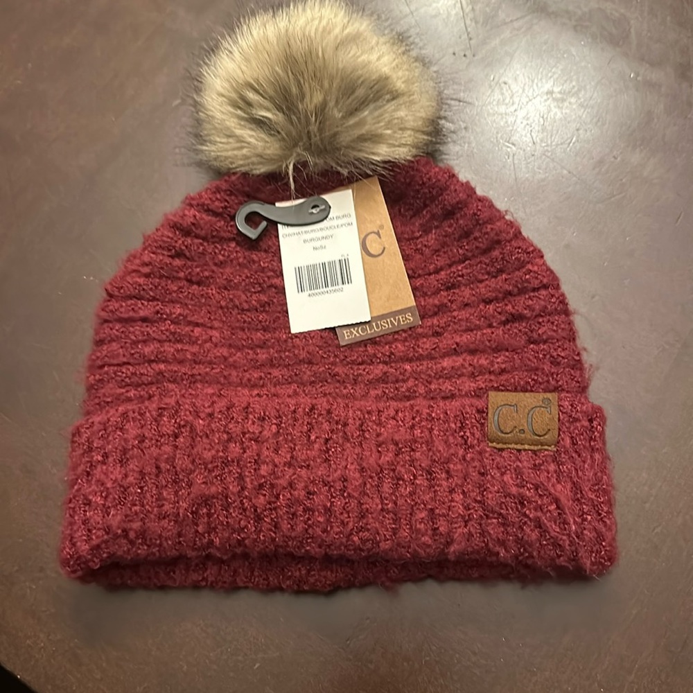 C.C. Winter hat. Burgundy/ deep red. NWT 100% polyester. One size fits all